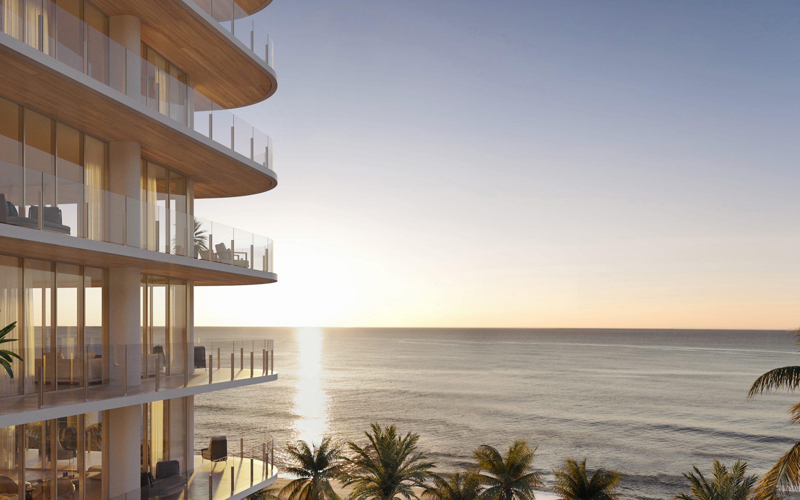 Full floor terraces at Ocean House Surfside condos on Miami oceanfront, with beach sunset view in the background.