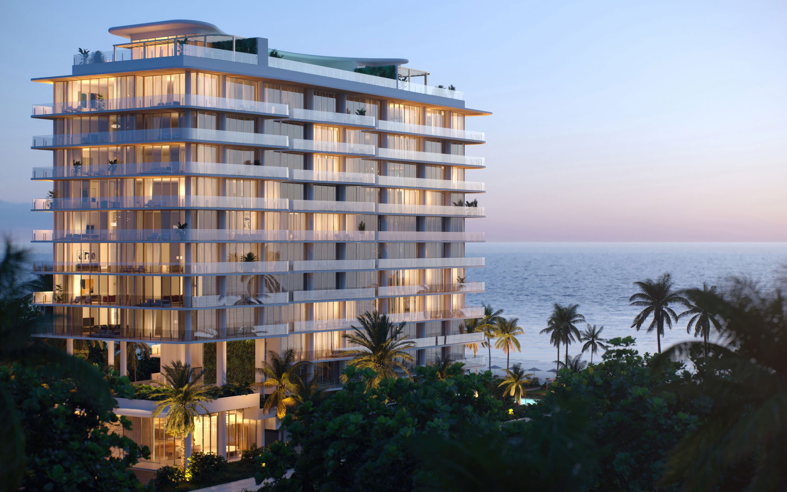 Exterior of Ocean House luxury condos in Surfside, Miami at dusk, with ocean view in background.