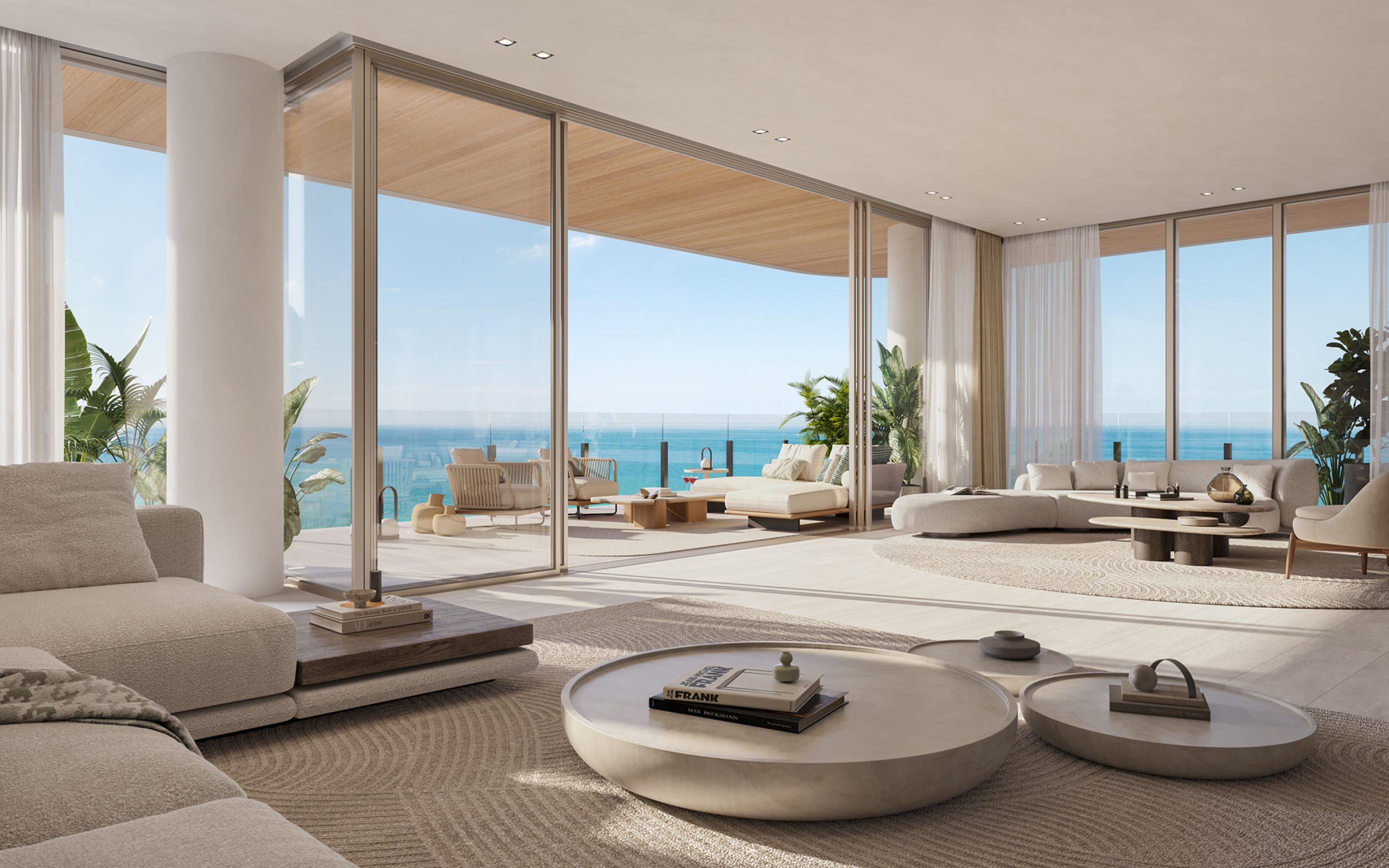 Spacious living room at Ocean House luxury residences in Surfside, Miami, featuring terrace with couches and ocean view.