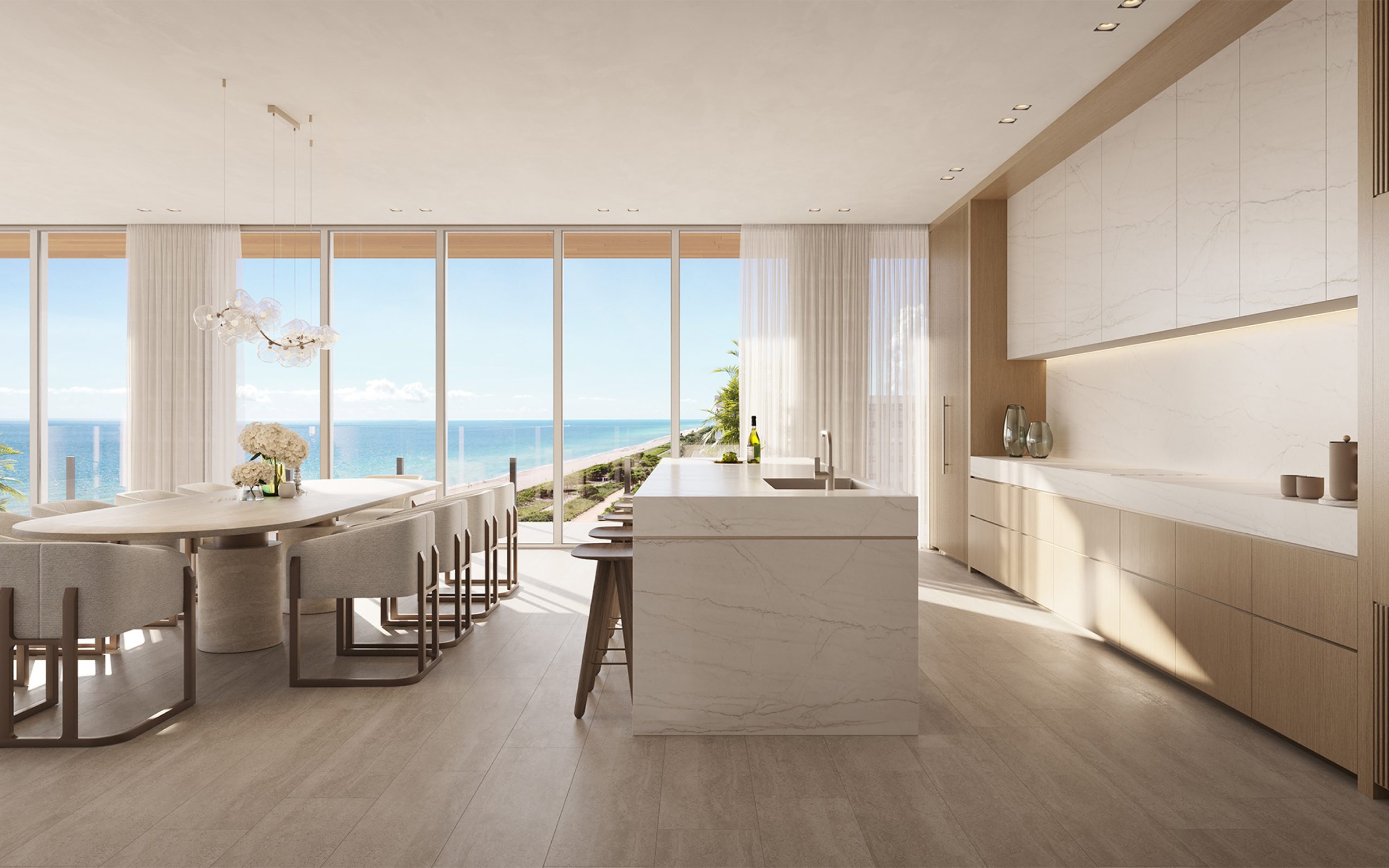 Luxury oceanfront condo kitchen and dining room at Ocean House residences in Surfside, Miami, with expansive ocean views.