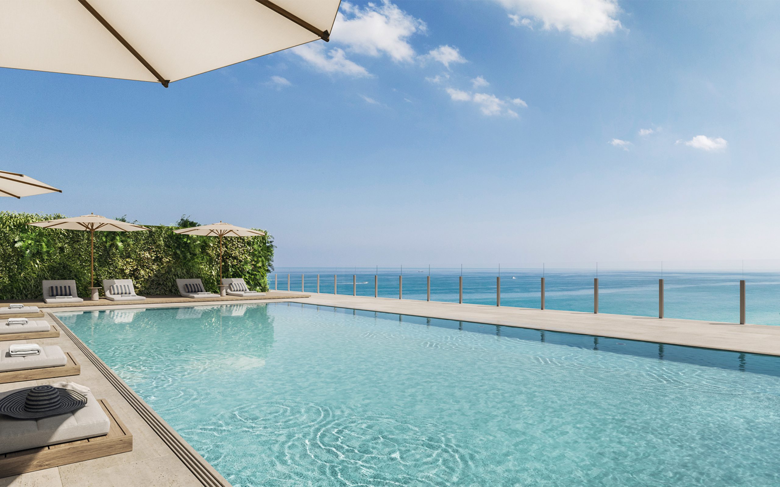 Large top floor outdoor pool deck on the oceanfront in Miami with ocean view at Ocean House luxury residences in Surfside.